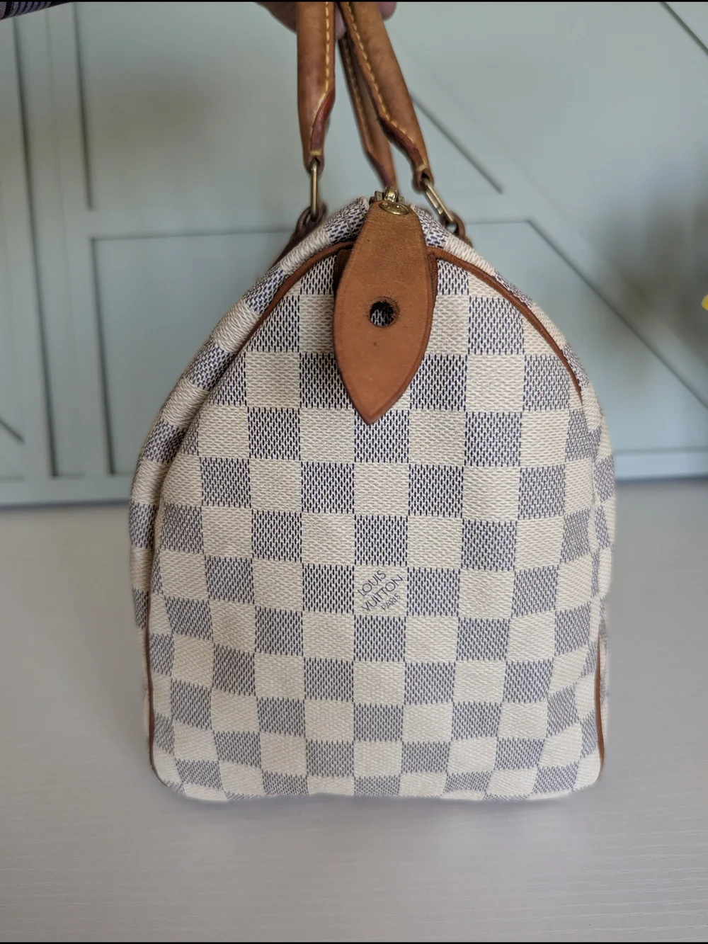Louis Vuitton Speedyhandbag styled in the iconic Damier Azur canvas pattern.